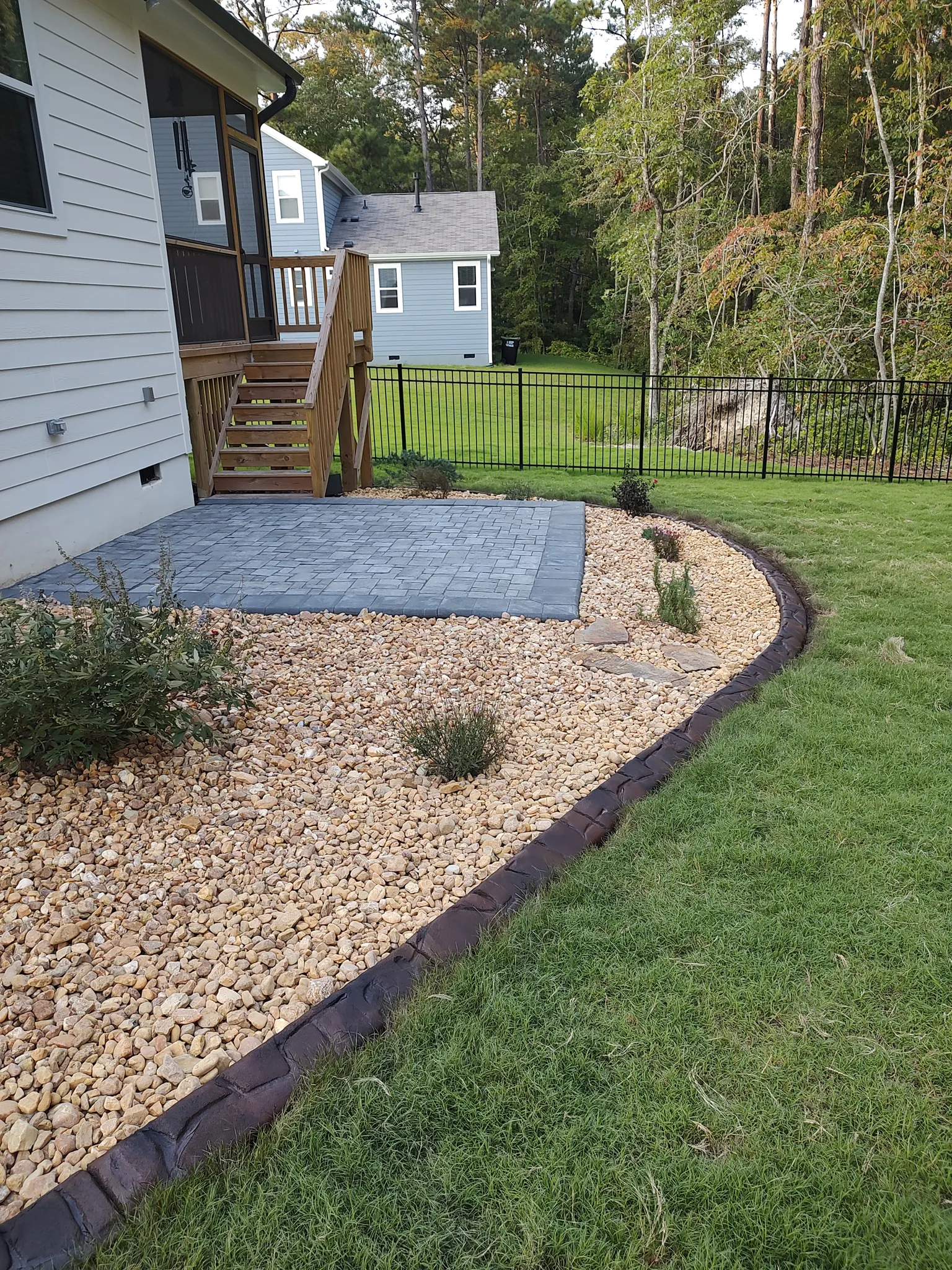 Paver patio bordered with pea gravel