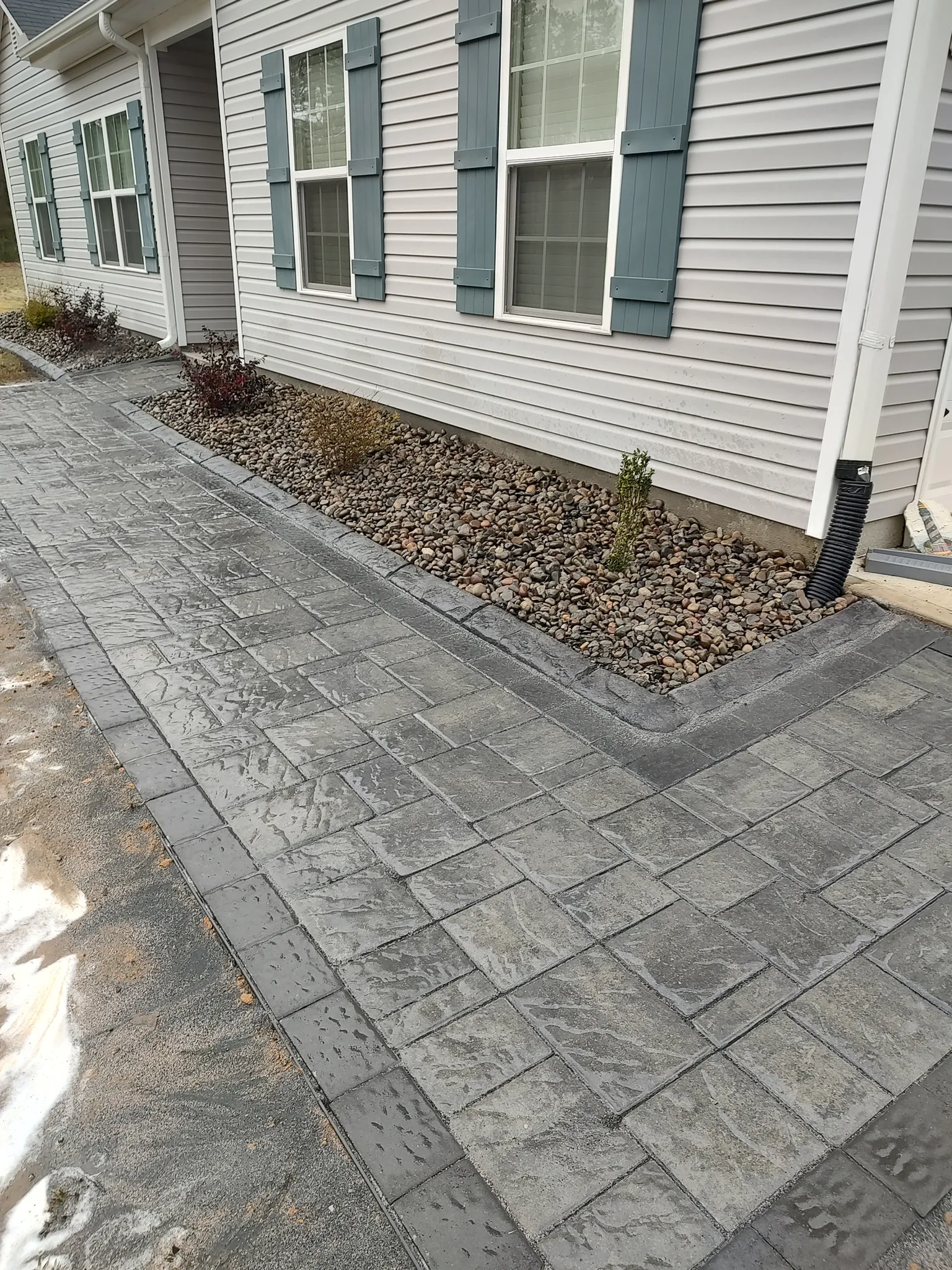 Square flagstone walkway through a lawn