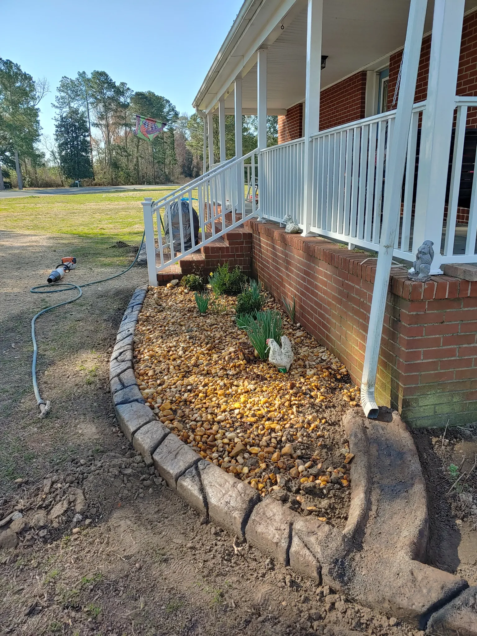 Concrete curbing installation with integrated drainage control along a landscape edge